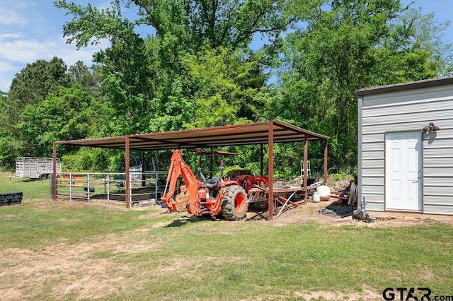 view of yard with a carport and fence