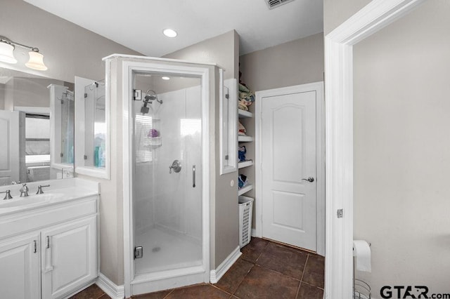 bathroom featuring a shower stall, vanity, tile patterned floors, and visible vents