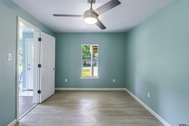 unfurnished bedroom with ceiling fan and light wood-type flooring