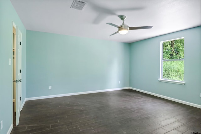 spare room with ceiling fan and dark hardwood / wood-style flooring