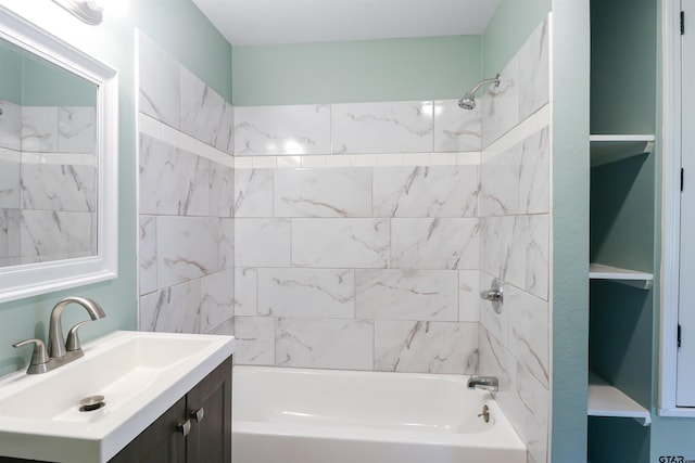 bathroom with vanity and tiled shower / bath combo