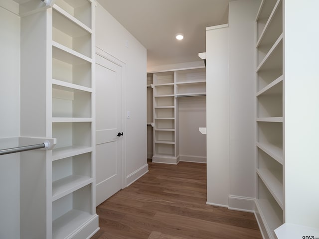 spacious closet featuring dark hardwood / wood-style flooring