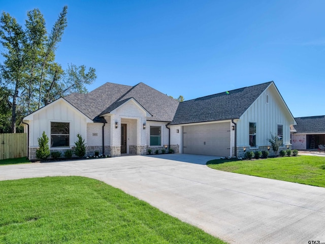 modern inspired farmhouse featuring a garage and a front yard