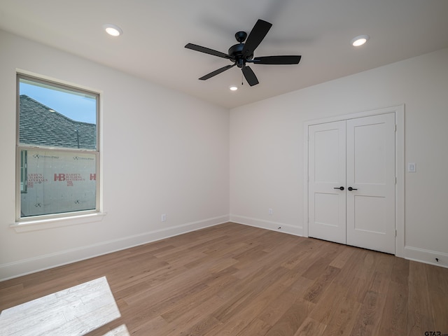 spare room featuring ceiling fan and light wood-type flooring