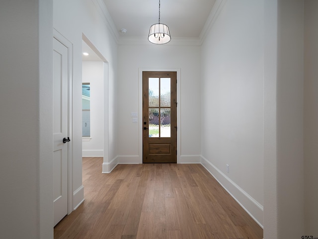 entryway with crown molding and light hardwood / wood-style flooring