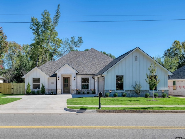 modern farmhouse style home with a front lawn