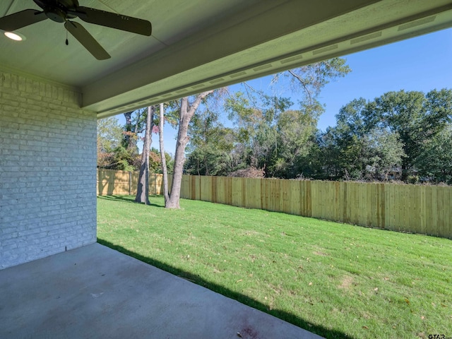 view of yard with ceiling fan and a patio area