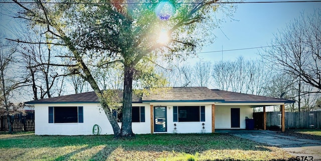 single story home featuring a carport and a front lawn