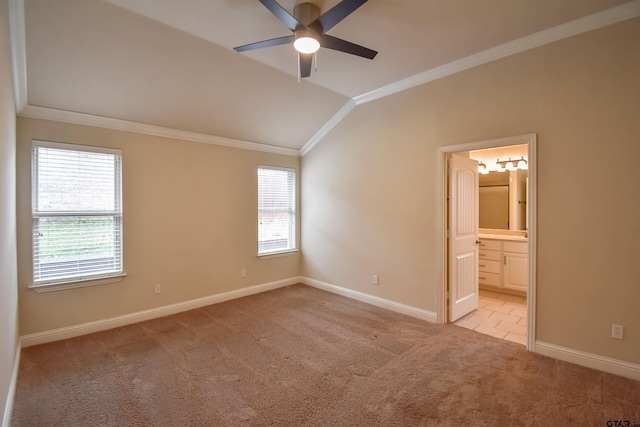 unfurnished bedroom with multiple windows, ornamental molding, vaulted ceiling, and light colored carpet