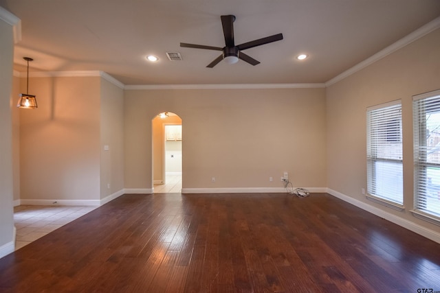 unfurnished room with crown molding, dark hardwood / wood-style floors, and ceiling fan