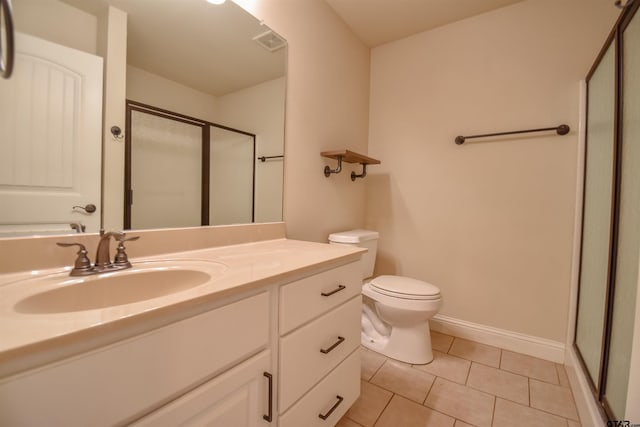 bathroom with an enclosed shower, vanity, tile patterned floors, and toilet