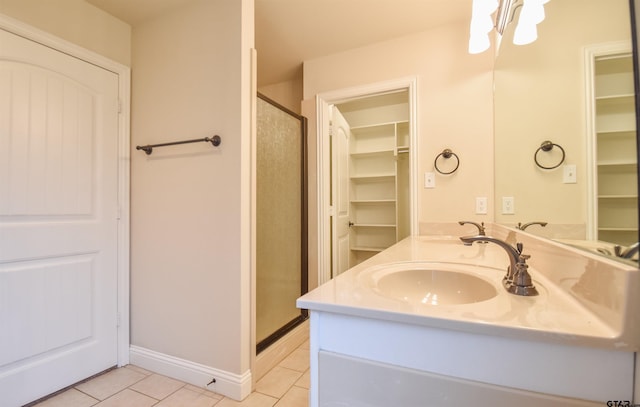 bathroom featuring tile patterned flooring, vanity, and an enclosed shower