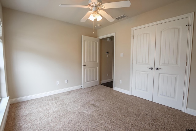 unfurnished bedroom with carpet floors, a closet, and ceiling fan