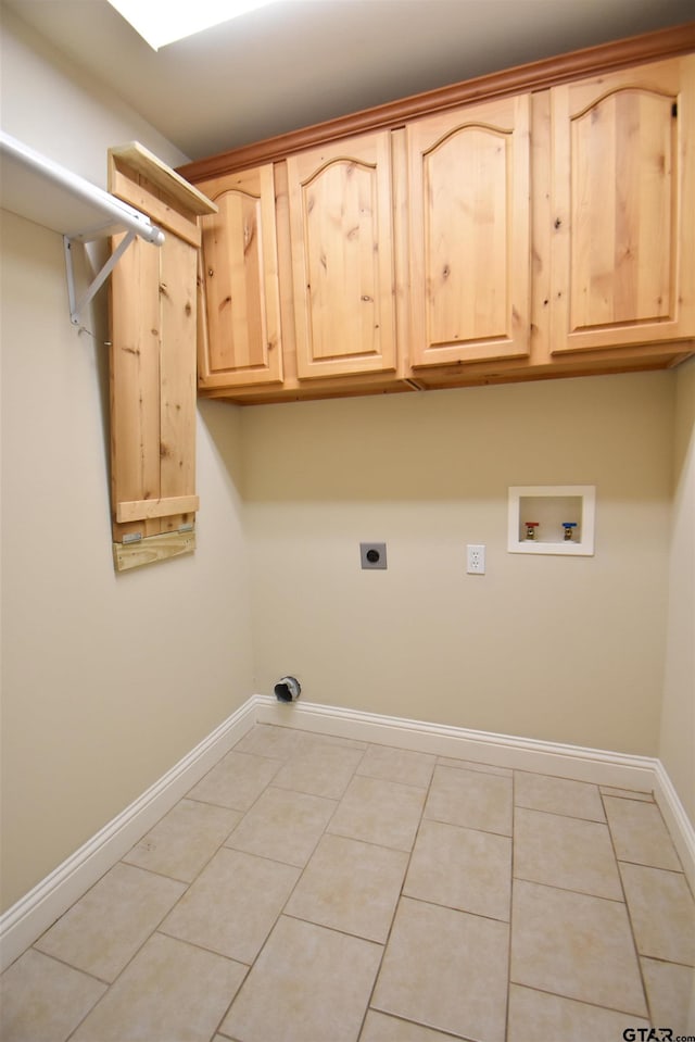 laundry room featuring cabinets, light tile patterned flooring, hookup for an electric dryer, and washer hookup