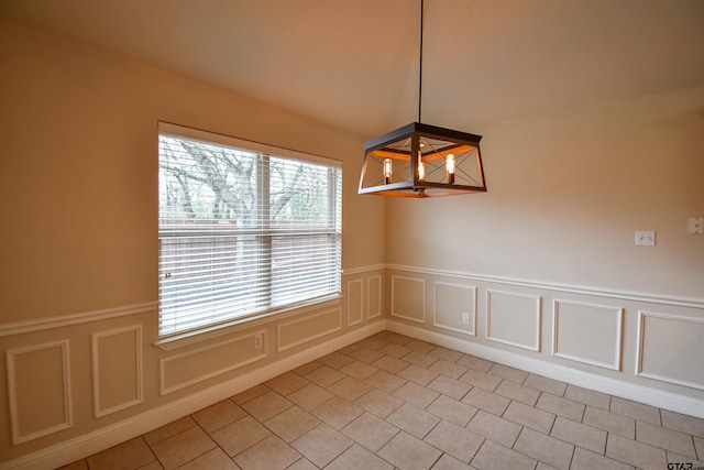 unfurnished dining area with a chandelier and light tile patterned floors