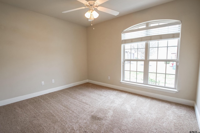 carpeted empty room with ceiling fan