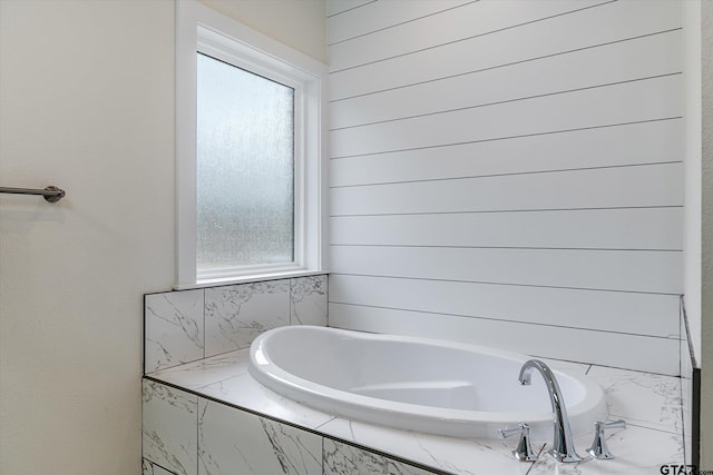 bathroom with tiled bath