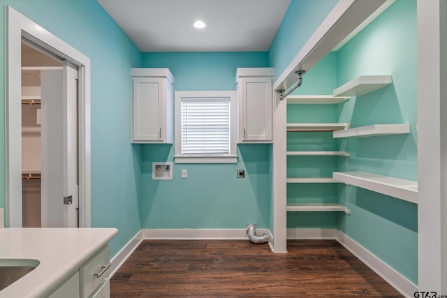 laundry room with hookup for an electric dryer, cabinets, dark wood-type flooring, and washer hookup