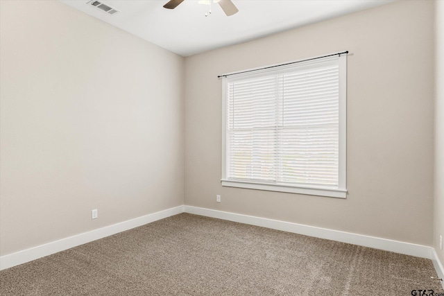 spare room featuring ceiling fan and carpet floors