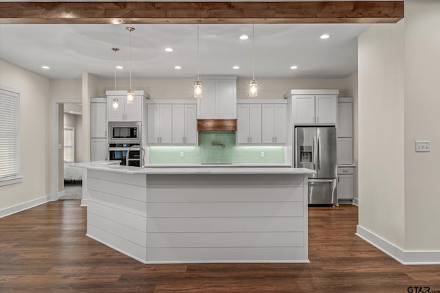 kitchen with pendant lighting, a spacious island, appliances with stainless steel finishes, tasteful backsplash, and white cabinetry