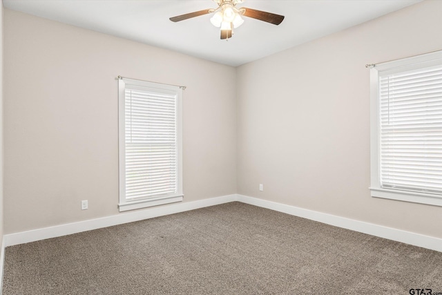 carpeted spare room with ceiling fan