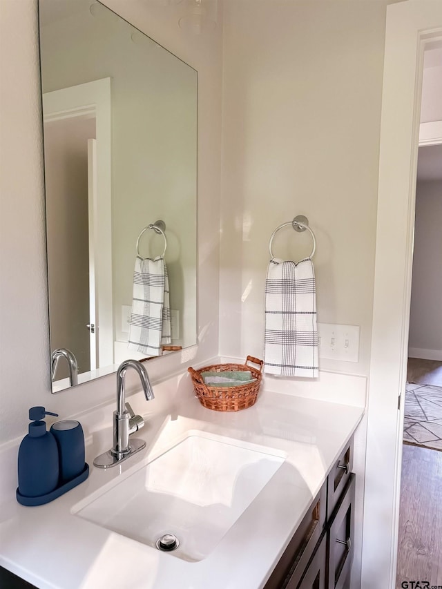 bathroom with hardwood / wood-style floors and vanity