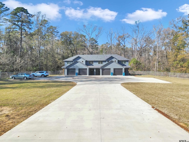 view of front facade with a front yard and a garage