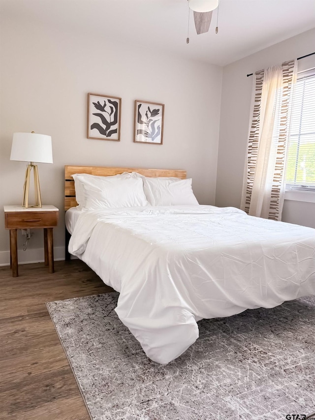 bedroom with ceiling fan and dark wood-type flooring