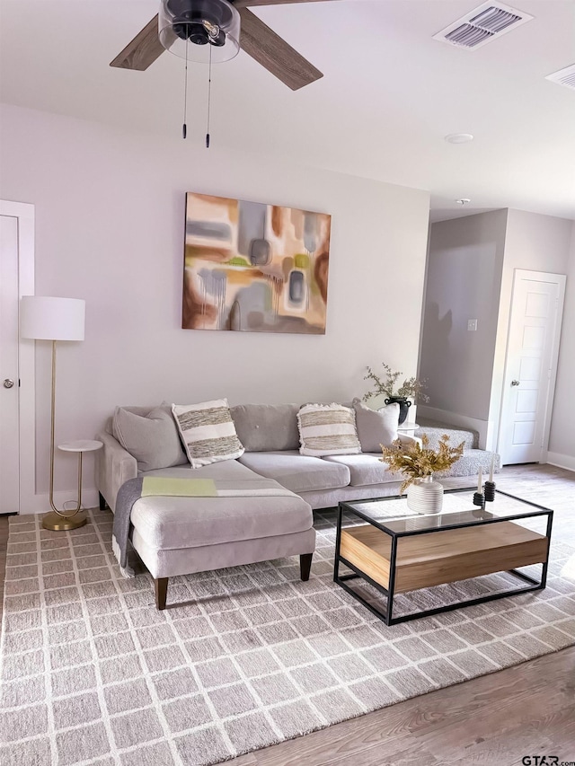 living room with ceiling fan and wood-type flooring