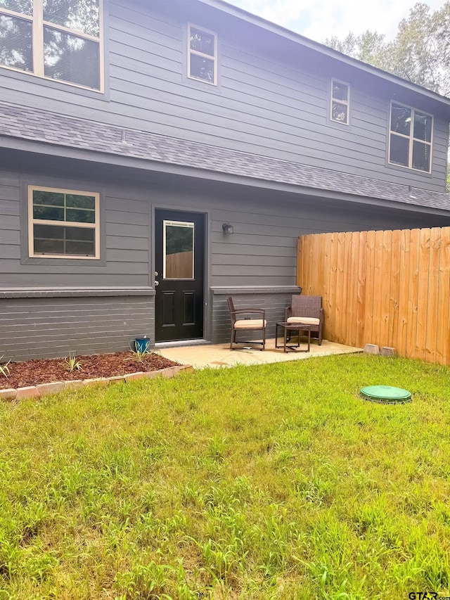 rear view of property with a lawn