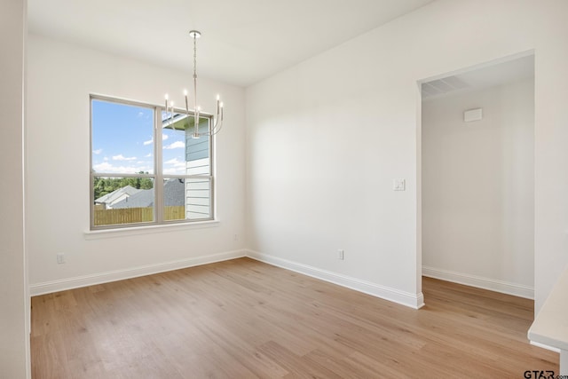 442 Mary Cir, Bullard, TX 75757 - spare room with a chandelier, light wood-type flooring, and baseboards
