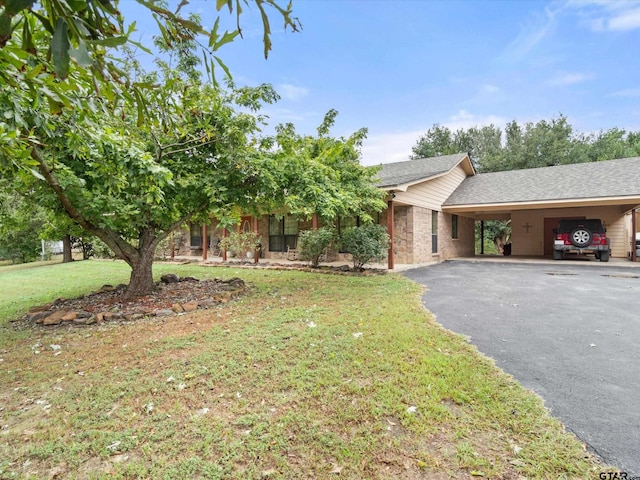 view of front of home with a front yard and a carport