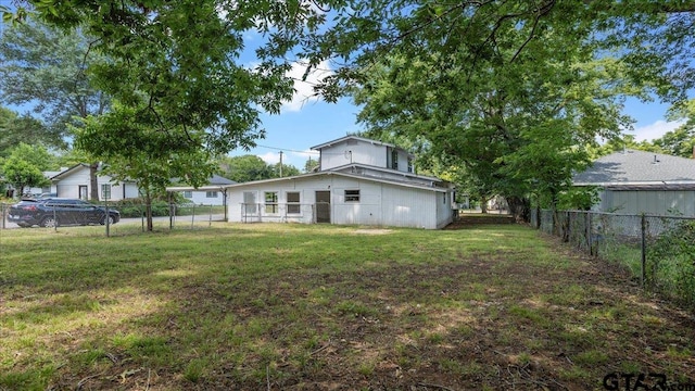 back of house with a lawn