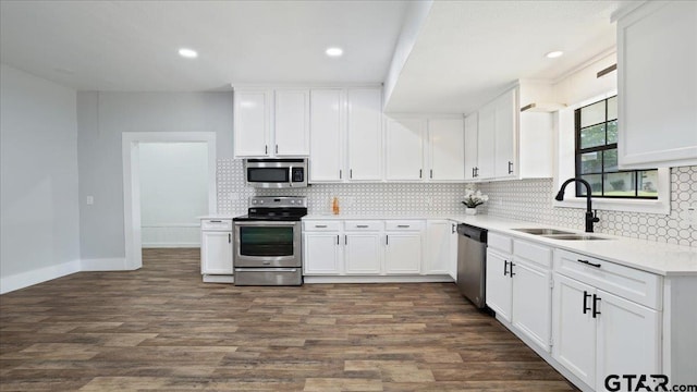 kitchen with dark hardwood / wood-style flooring, white cabinetry, appliances with stainless steel finishes, and sink