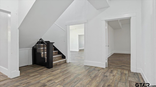 bonus room featuring dark hardwood / wood-style flooring and vaulted ceiling