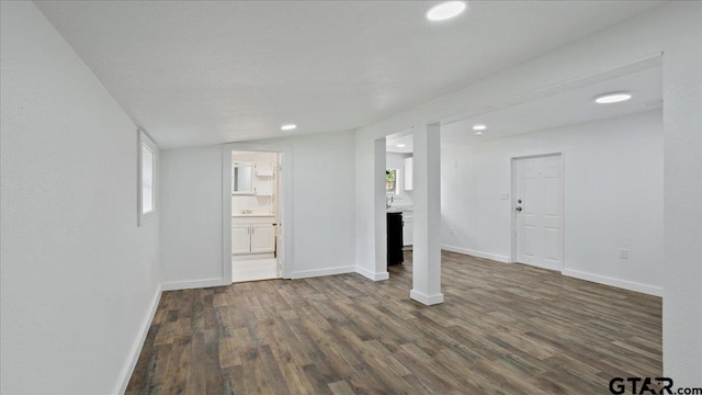 unfurnished living room with dark hardwood / wood-style flooring