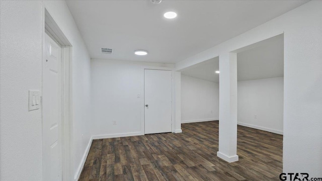 basement featuring dark hardwood / wood-style flooring