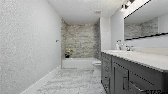 full bathroom featuring vanity, toilet, and tiled shower / bath combo