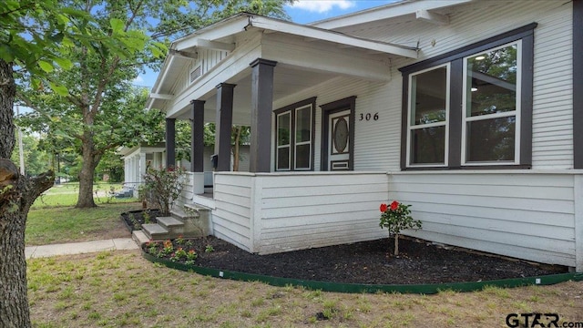 view of side of property with a yard and a porch