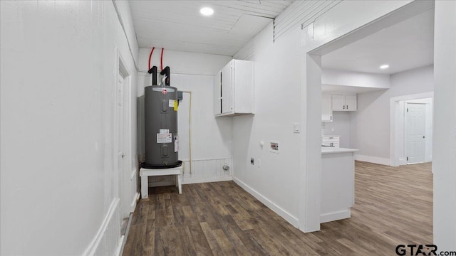 laundry area with cabinets, washer hookup, hookup for an electric dryer, water heater, and dark hardwood / wood-style flooring