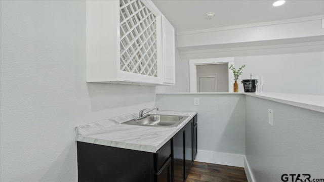 interior space with white cabinetry, sink, and dark hardwood / wood-style floors