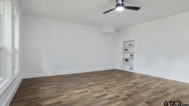 spare room with ceiling fan, wood-type flooring, and built in features