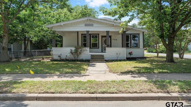 view of front of property with a porch and a front yard