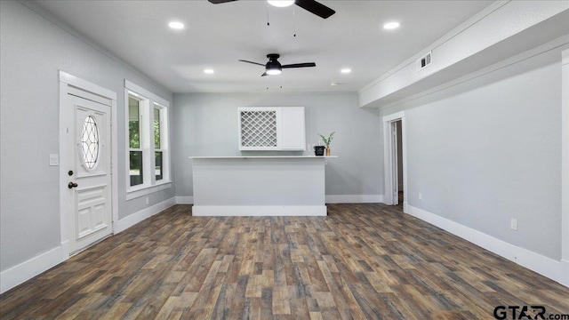 unfurnished living room with dark wood-type flooring, ceiling fan, and crown molding