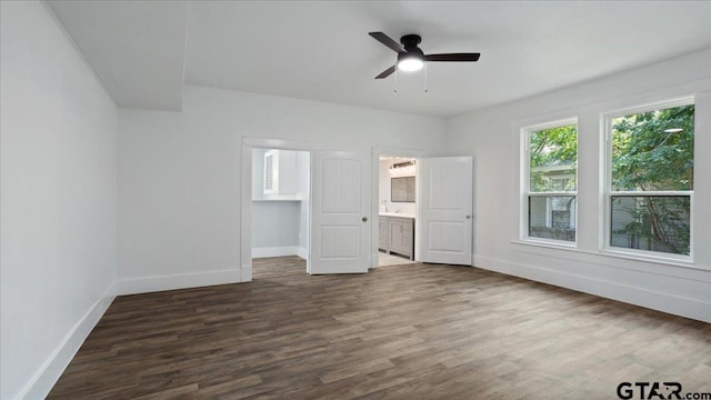 unfurnished bedroom with dark wood-type flooring, ceiling fan, and ensuite bathroom