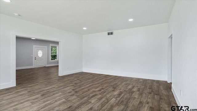 unfurnished room featuring dark wood-type flooring