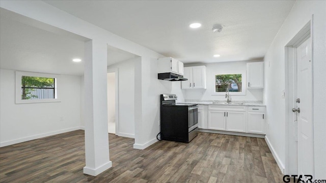 kitchen with stainless steel electric range, dark hardwood / wood-style floors, and white cabinets