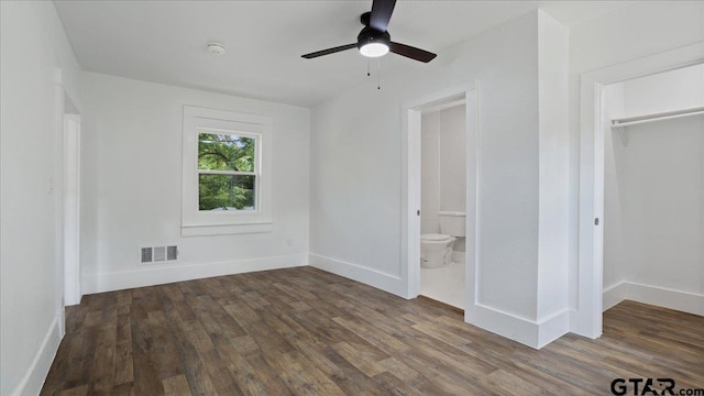 unfurnished bedroom with a closet, ceiling fan, dark hardwood / wood-style floors, and ensuite bathroom