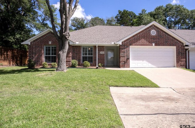 1521 Rice Rd Unit E105, Tyler, TX 75703 - single story home with brick siding, an attached garage, driveway, and roof with shingles
