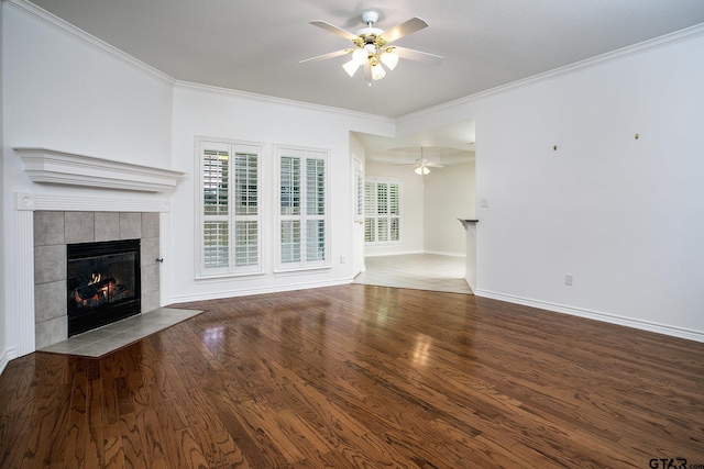 1521 Rice Rd Unit E105, Tyler, TX 75703 - unfurnished living room featuring a fireplace, ceiling fan, crown molding, wood finished floors, and baseboards